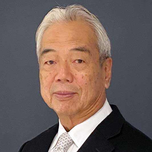 Yoshihiro Imaizumi pictured from the shoulders up, wearing a black suit and white shirt