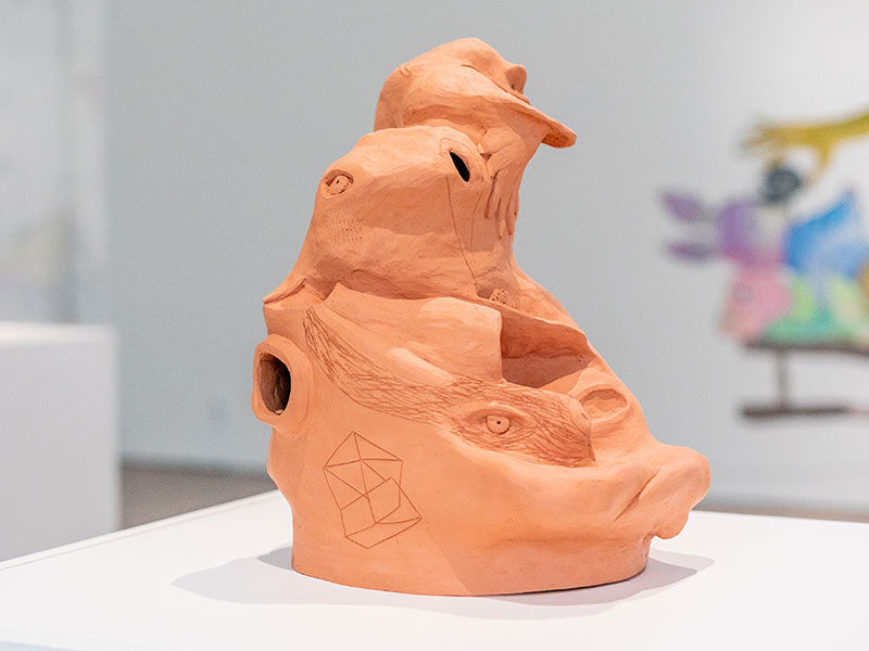 A terracotta ceramic sculpture with hybrid animal forms