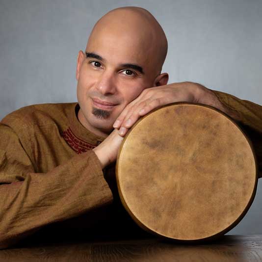 Portrait of Ziya Tabassian with a drum